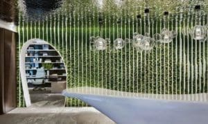 A showroom with green walls adorned with Melbourne wallpaper.