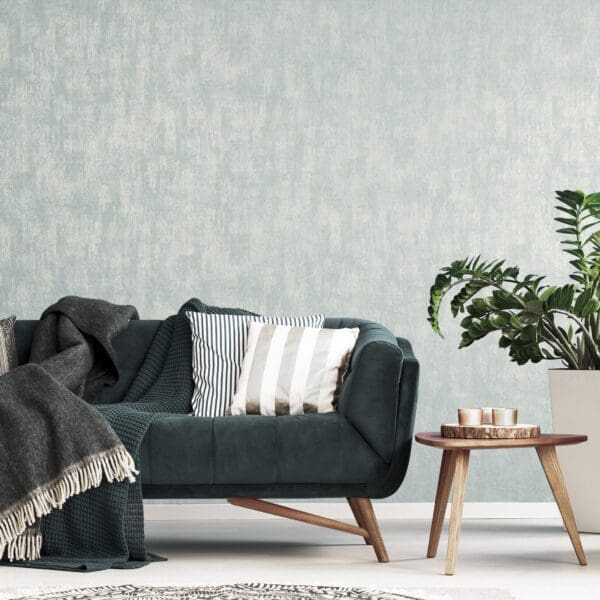 Patterned cushions on sofa next to wooden table and plant in dar MERCURY STONE BLUE